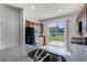 Kitchen featuring granite counters, wood cabinets, stainless steel appliances, and sliding doors to backyard at 251 Domus Ln, Casselberry, FL 32707
