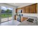 Well-lit kitchen featuring granite counters, wood cabinets, tile floors, and stainless steel appliances at 251 Domus Ln, Casselberry, FL 32707