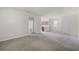 Spacious living room leading to the kitchen with carpet, neutral walls, and natural light at 251 Domus Ln, Casselberry, FL 32707