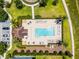 Overhead view of community pool area, with lounge chairs and tables for residents to enjoy, surrounded by greenery at 251 Domus Ln, Casselberry, FL 32707