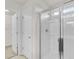 Bright white shower with clear glass doors with a view to a walk-in closet at 251 Domus Ln, Casselberry, FL 32707