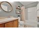 Cozy bathroom with a vanity, toilet, and tub with shower with neutral walls and flooring at 2563 Breezy Meadow Rd, Apopka, FL 32712