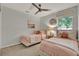 Bright bedroom with two twin beds, plush bedding, and a window with natural light at 2563 Breezy Meadow Rd, Apopka, FL 32712