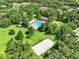 Aerial view showcasing community pool, volleyball court, and green spaces, offering diverse recreational opportunities at 2563 Breezy Meadow Rd, Apopka, FL 32712