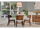 Dining room features a round table, modern chairs, large windows and access to the back yard at 2563 Breezy Meadow Rd, Apopka, FL 32712