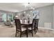 Well-lit dining room featuring modern chandelier, large painting, and seating for six at 2563 Breezy Meadow Rd, Apopka, FL 32712