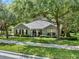 Charming home with a well-maintained lawn, mature trees, and neutral exterior paint at 2563 Breezy Meadow Rd, Apopka, FL 32712