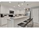 Bright kitchen with white cabinets, modern appliances, and a breakfast bar for dining at 2563 Breezy Meadow Rd, Apopka, FL 32712