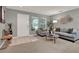 Cozy living room featuring neutral walls, plush seating, and lots of natural light at 2563 Breezy Meadow Rd, Apopka, FL 32712