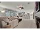 Open-concept living room flows into a modern kitchen with a breakfast bar at 2563 Breezy Meadow Rd, Apopka, FL 32712