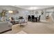 Open-concept living and dining area with neutral walls and carpet at 2563 Breezy Meadow Rd, Apopka, FL 32712