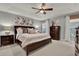Spacious bedroom featuring a tray ceiling, a ceiling fan, and elegant, neutral decor at 2563 Breezy Meadow Rd, Apopka, FL 32712