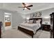 Inviting bedroom featuring a king bed, ceiling fan, neutral color palette, and ensuite bathroom at 2563 Breezy Meadow Rd, Apopka, FL 32712