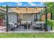 Charming covered patio with stylish furniture, an outdoor rug, and cozy ambiance for relaxation and gatherings at 2563 Breezy Meadow Rd, Apopka, FL 32712