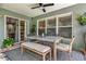 Cozy patio featuring a modern outdoor dining set, ceiling fan, and access to indoor living spaces at 2563 Breezy Meadow Rd, Apopka, FL 32712