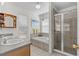 Bathroom featuring double sinks, a garden tub, and a tiled shower with a glass door at 2850 Spring Heather Pl, Oviedo, FL 32766