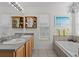 Bright bathroom features double sinks, a bathtub, and soft natural light at 2850 Spring Heather Pl, Oviedo, FL 32766