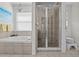 Bathroom with a large bathtub and glass-enclosed shower; ample natural light at 2850 Spring Heather Pl, Oviedo, FL 32766