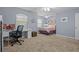 Bedroom offers both relaxation and productivity with a cozy bed and a functional desk area at 2850 Spring Heather Pl, Oviedo, FL 32766