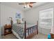Bright bedroom with a four-poster bed, ceiling fan, and natural light from the window at 2850 Spring Heather Pl, Oviedo, FL 32766