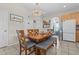 Bright dining area featuring a wooden table and bench seating under a decorative chandelier at 2850 Spring Heather Pl, Oviedo, FL 32766
