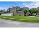 Exterior view of a two-story home, showcasing the landscaped yard and attached garage at 2850 Spring Heather Pl, Oviedo, FL 32766