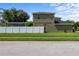 View of a two-story home featuring a fenced yard and well-maintained lawn on a sunny day at 2850 Spring Heather Pl, Oviedo, FL 32766