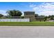 Side view of a two-story home with a white picket fence and well-maintained lawn at 2850 Spring Heather Pl, Oviedo, FL 32766