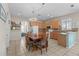Bright kitchen featuring a large dining table, tile floors, wooden cabinetry, and modern appliances at 2850 Spring Heather Pl, Oviedo, FL 32766