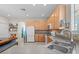 Bright kitchen featuring wooden cabinets, white appliances, sink and dining area at 2850 Spring Heather Pl, Oviedo, FL 32766