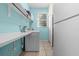 Functional laundry room featuring a washer, dryer, utility sink, and ample storage space at 2850 Spring Heather Pl, Oviedo, FL 32766