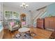 Comfortable living room featuring hardwood floors, a staircase, a display cabinet, and abundant natural light at 2850 Spring Heather Pl, Oviedo, FL 32766