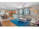 Open-concept living room and kitchen featuring hardwood floors and a large sectional sofa at 2850 Spring Heather Pl, Oviedo, FL 32766