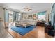Inviting living room with a large sectional sofa, hardwood floors, and access to the patio at 2850 Spring Heather Pl, Oviedo, FL 32766