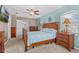 Comfortable main bedroom featuring a wooden bed frame, cozy carpet, and a ceiling fan at 2850 Spring Heather Pl, Oviedo, FL 32766