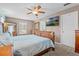 Main bedroom with a ceiling fan, a television, and a mirror on the wall at 2850 Spring Heather Pl, Oviedo, FL 32766