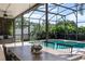 Inviting patio area featuring a beautiful swimming pool, dining table, and comfortable lounge chairs at 2850 Spring Heather Pl, Oviedo, FL 32766