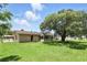 Expansive backyard featuring a lush green lawn and a large, mature shade tree, creating a private outdoor space at 2908 Clear Way, Orlando, FL 32805