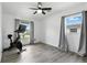 Bright bedroom featuring hardwood floors, modern ceiling fan, and plenty of natural light at 2908 Clear Way, Orlando, FL 32805