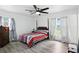 Bright bedroom featuring hardwood floors, a classic four-poster bed, and plenty of natural light at 2908 Clear Way, Orlando, FL 32805