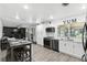 Modern open kitchen flowing to the living area, featuring bright white cabinetry and stainless appliances at 2908 Clear Way, Orlando, FL 32805