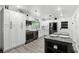Stylish kitchen with white cabinets, stainless steel appliances, island, and plentiful natural light at 2908 Clear Way, Orlando, FL 32805