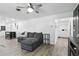 Spacious living room with a comfortable gray sofa, plank flooring, and views of other home areas at 2908 Clear Way, Orlando, FL 32805