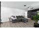Cozy living room with plank floors, a plush gray sectional, and inviting decor elements throughout at 2908 Clear Way, Orlando, FL 32805