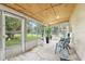 Enclosed sunroom with lots of windows bringing the outdoors in, tile floors, and room to relax at 2908 Clear Way, Orlando, FL 32805
