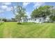 Expansive backyard featuring well-maintained lawn, mature trees, and a partially fenced perimeter at 323 Scotland Dr, Daytona Beach, FL 32117
