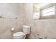 Bathroom featuring tiled walls, a toilet, and a mirror above the toilet at 323 Scotland Dr, Daytona Beach, FL 32117