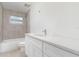Bathroom featuring a white vanity, quartz countertop, and tiled shower-tub, and updated fixtures at 323 Scotland Dr, Daytona Beach, FL 32117