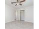 Bedroom featuring tile floors, a ceiling fan, and closet at 323 Scotland Dr, Daytona Beach, FL 32117