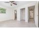 Bright bedroom featuring tile floors, a ceiling fan, and a walk-in closet at 323 Scotland Dr, Daytona Beach, FL 32117